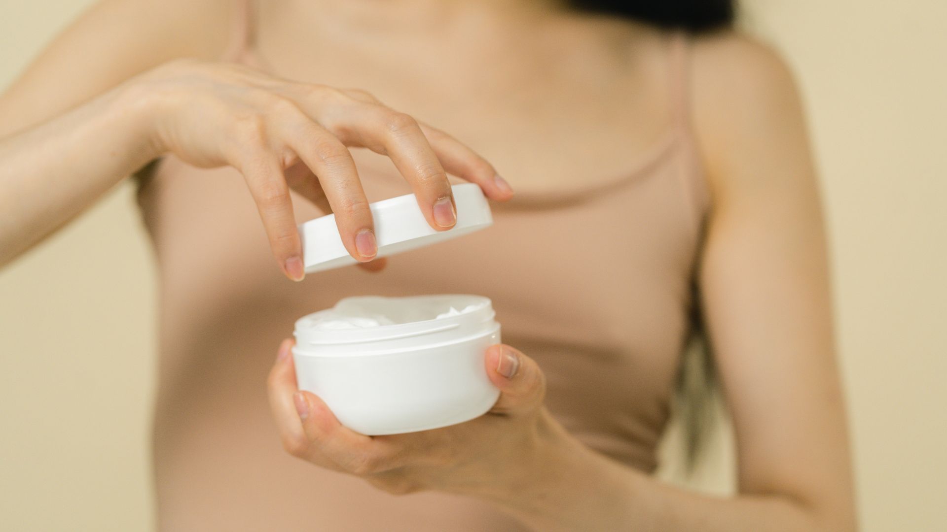 Woman holding moisturizer
