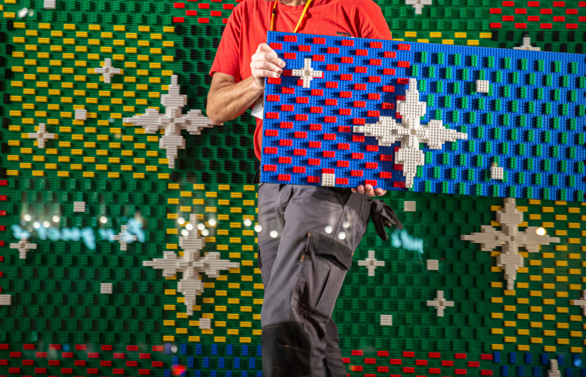 Louis Vuitton and lego collaboration. Bag at luxury brand shop window with  creative colorful background. Stock Photo