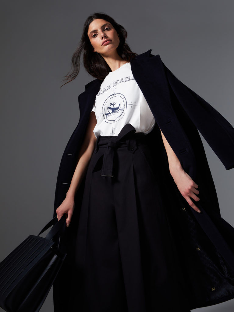Woman with Louis Vuitton Pale Blue Bag before Max Mara Fashion