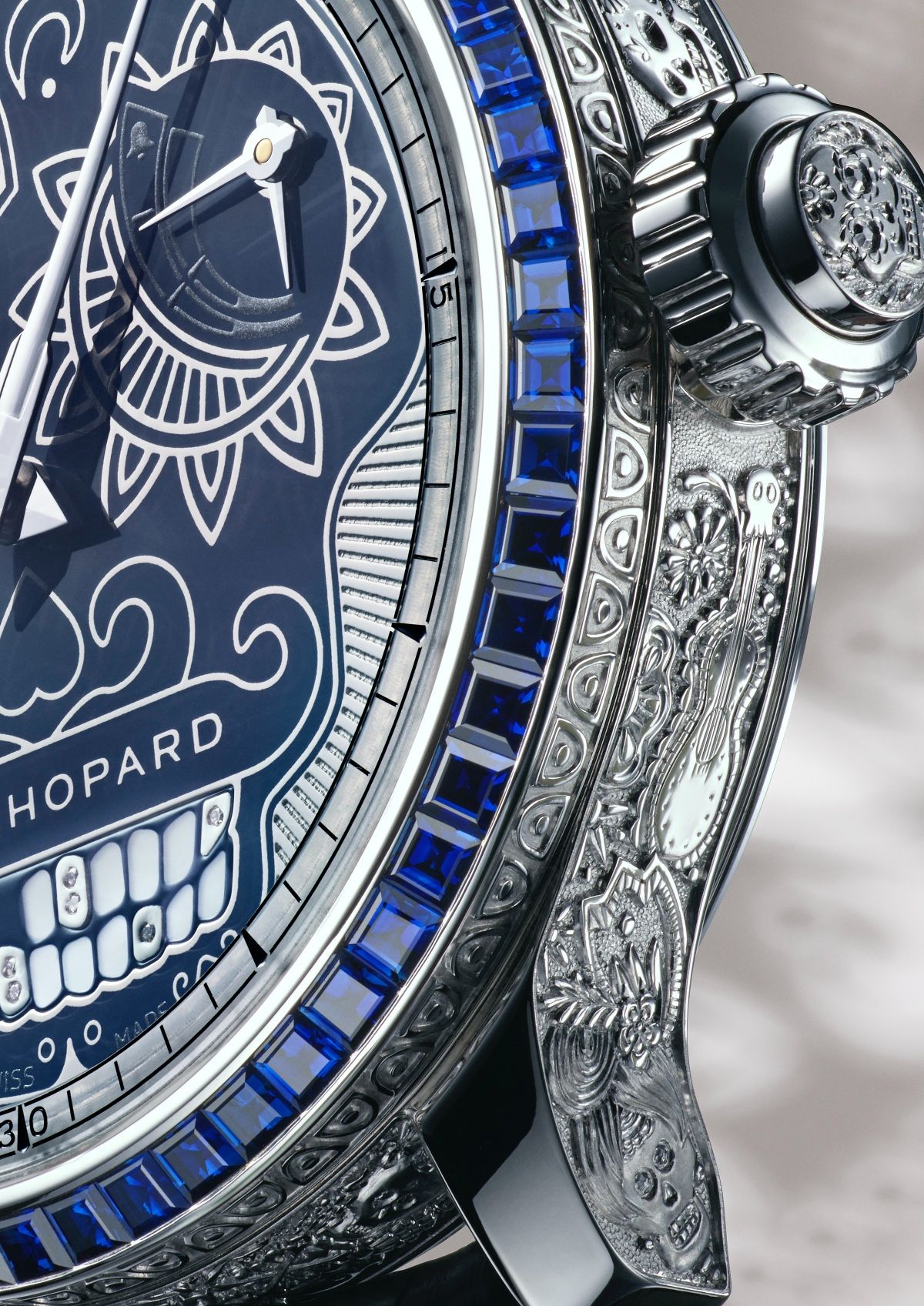 The entire case is hand-engraved and topped with a bezel in sapphires