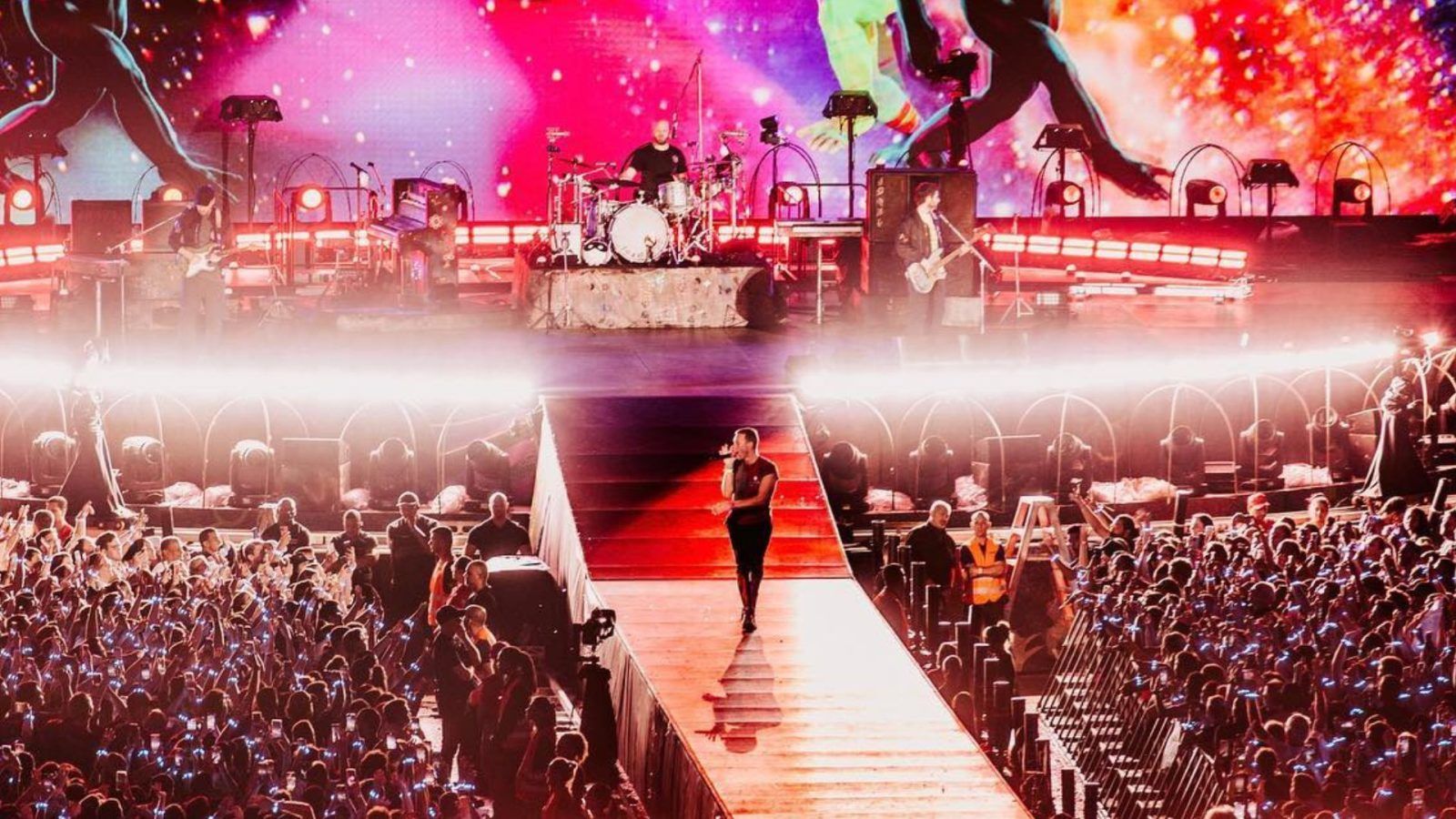 Coldplay band members performing live in *2023*