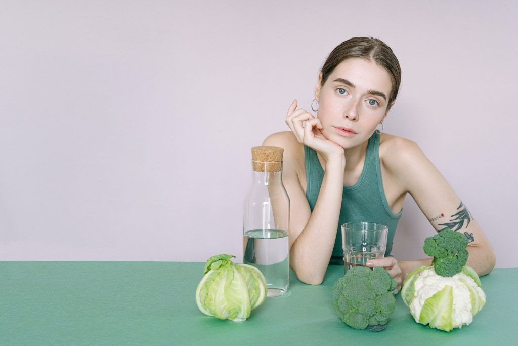 Girl with green veggies & water 