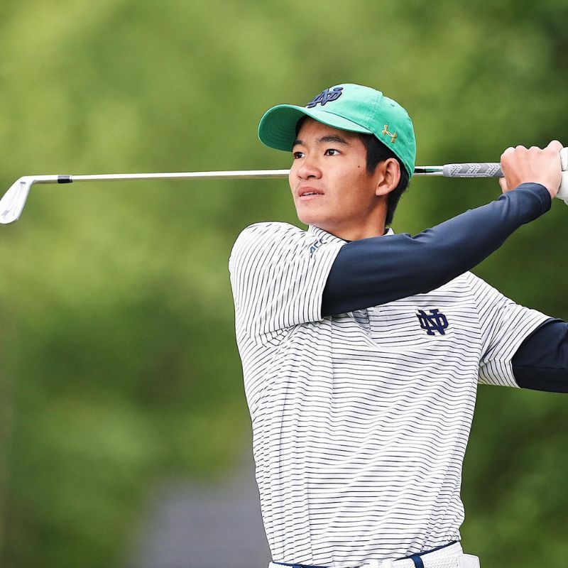 Golfer Holding Golf Club and a Louis Vuitton Bag