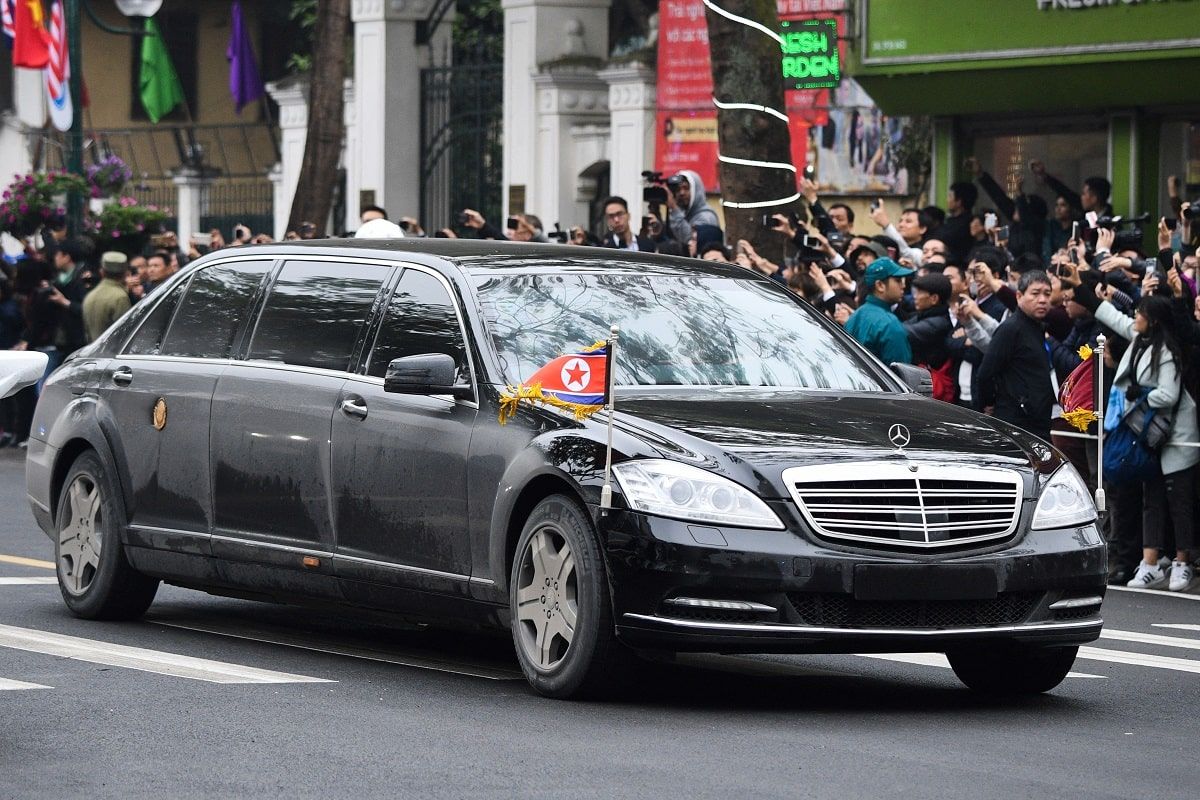 Security personnel surround the official vehicle of Indian Prime